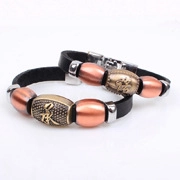 Close-up of vintage leather bracelet set with embossed PK metal beads and retro charms