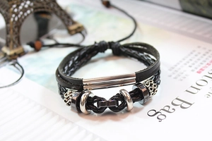 Detail of multi-layer woven leather bracelet with silver metal beads and vintage tubes