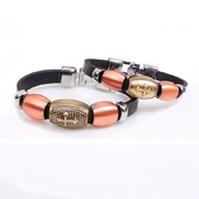 Macro detail of cross-engraved leather bracelets with bronze beads and metallic charms