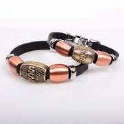 Detail of leather beaded bracelets featuring rose gold beads and vintage S letter charm