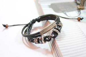 Detail of adjustable woven leather bracelet with metal beads and hematite accents