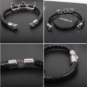 Detailed view of punk black leather bracelet with silver spikes and magnetic clasp