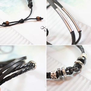 Detailed macro view of multi-layer braided leather bracelet with metal tubes and beads