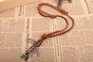 Detail of vintage leather necklace featuring Eiffel Tower and bronze alloy pendants
