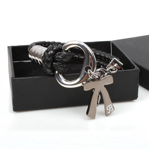 Braided black leather bracelet with silver bow pendant and engraved letter B detail