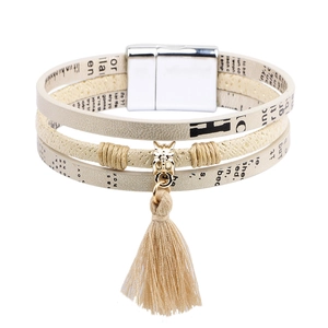 Multi-layer beige PU leather bracelet with gold animal charm and tassel on white background
