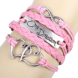 Pink braided leather bracelet with One Direction plate, heart and infinity charms