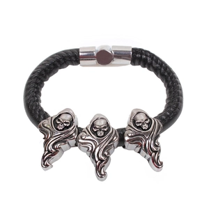 Gothic punk men's black braided leather bracelet with three silver skull accents