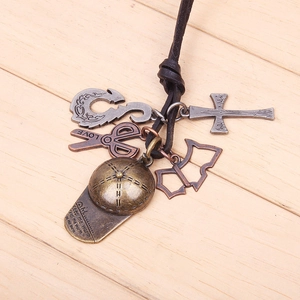 Retro bronze cap and scissors leather pendant necklace on a natural wooden background