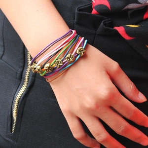 Handmade woven owl bracelets in colorful wax cord with vintage metal charm
