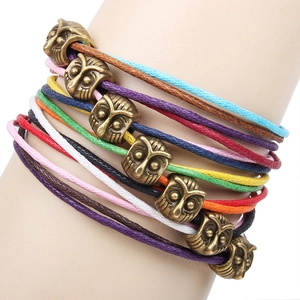 Bohemian multi-layer colorful wax cord bracelet featuring bronze owl beads on wrist