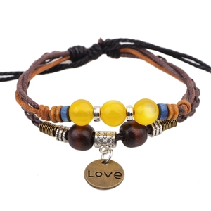 Multilayer handmade woven bracelet with yellow cat eye beads and Love pendant
