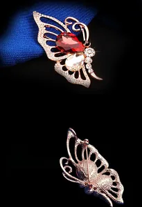 Détail de la broche papillon en or rose avec cristaux rouges et fermoir arrière