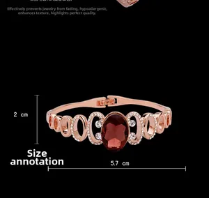 Detail of rose gold bangle with oval purple crystal and dimensions 5.7cm by 2cm