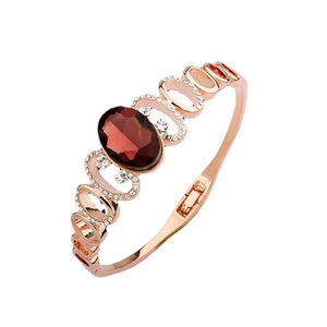 Elegant rose gold bracelet with oval dark red gemstone and inlaid white crystals