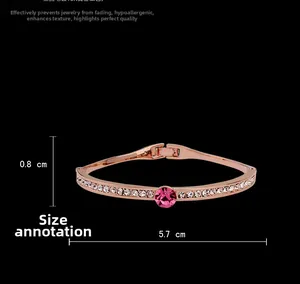 Detail of rose gold plated bracelet featuring a pink center stone and crystal accents