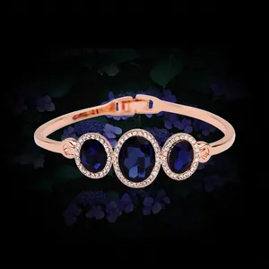 Rose gold bangle featuring three dark blue crystals surrounded by pavé diamonds