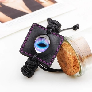 Handcrafted black leather braided bracelet with vibrant blue evil eye and purple stitching