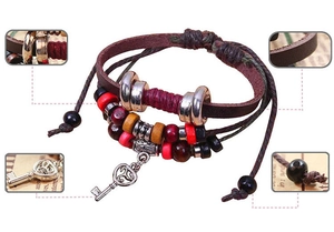 Detailed macro view of vintage leather wrap bracelet with silver key charm and wooden beads