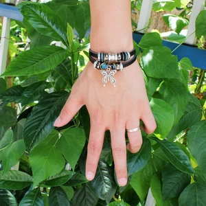 Handmade leather rope bracelet featuring a butterfly pendant and beads on a wrist