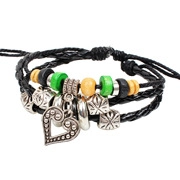 Macro view of multi-layer woven bracelet with silver heart pendant and wooden beads