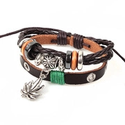 Detail of multilayer brown leather braided bracelet with metal leaf charm and beads