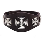 Close-up of punk leather bracelet featuring three silver metal crosses on dark strap