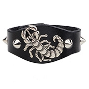 Close-up of a punk leather bracelet featuring a silver metal scorpion and sharp rivets