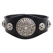 Close-up of wide black leather bracelet with dragon relief and metal cross studs