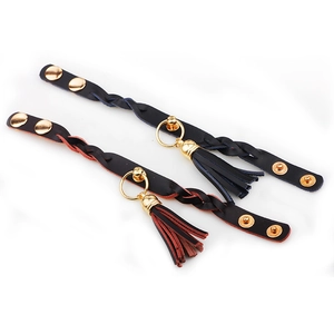 Set of two braided black and red leather bracelets with gold rings and fringe tassels