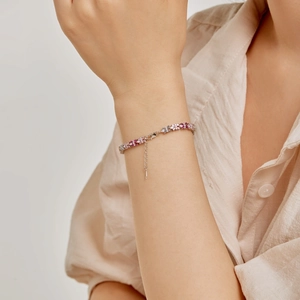 Bracciale in argento S925 con fiori in zirconia rosa e bianchi indossato da una donna