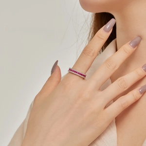 Close-up of S925 silver ring featuring red gemstones and sparkling pavé diamonds on finger