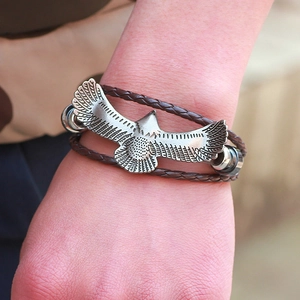 Vintage braided brown leather bracelet featuring a silver-tone metal eagle ornament