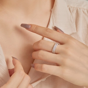 Macro detail of S925 sterling silver multi-row pavé diamond ring on a model hand