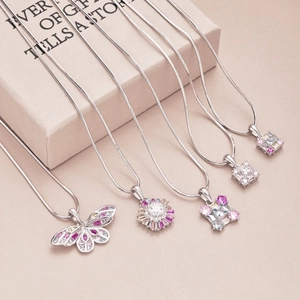 Macro detail of S925 silver necklaces with colorful butterfly and floral zircon pendants