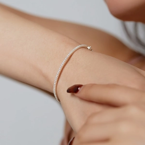 S925 sterling silver thin bracelet with single row micro-set sparkling zircons on model wrist