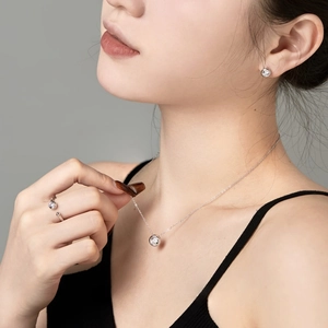 Elegant 925 sterling silver jewelry set featuring a necklace, earrings and open ring