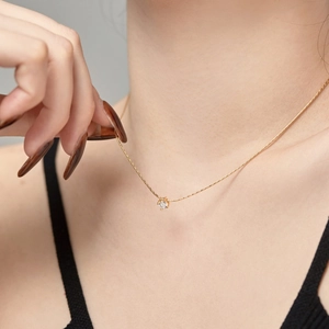 Close-up of S925 sterling silver gold necklace with a 4mm zircon pendant on the neck