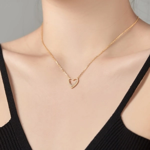 S925 silver gold heart pendant necklace with shimmering cubic zirconia stones on a model