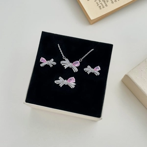 Detailset aus silbernem Schleifenschmuck mit rosa Birnensteinen in einer schwarzen Box
