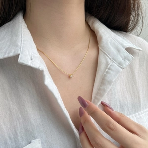 Elegant minimalist S925 sterling silver gold necklace with a 4mm zircon pendant on a model