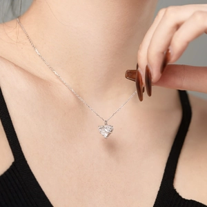 Macro shot of S925 silver necklace featuring a heart-shaped zircon pendant with 3-prong setting