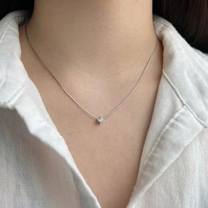 Elegant S925 sterling silver necklace with a 4mm zircon pendant worn on a female neck