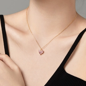 Detail shot of heart-shaped pink zircon pendant on a gold-plated sterling silver necklace