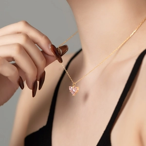 Close-up of heart-shaped pink zircon pendant on a delicate gold chain for women