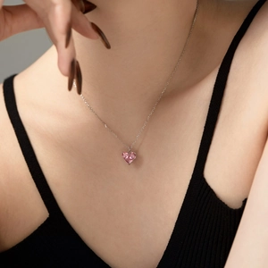 Model wearing a S925 sterling silver necklace with a heart-shaped pink zircon pendant