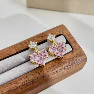 Detailed macro shot of heart-shaped pink zircon earrings set in gold S925 silver finish