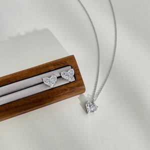 Close-up of S925 sterling silver heart jewelry set with zircon in a wooden gift box
