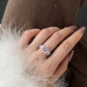 Luxurious S925 sterling silver ring featuring heart-shaped pink diamond on model's finger