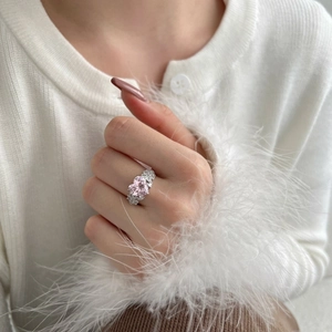 Macro shot of luxury S925 silver heart ring with sparkling pink gemstone on a model